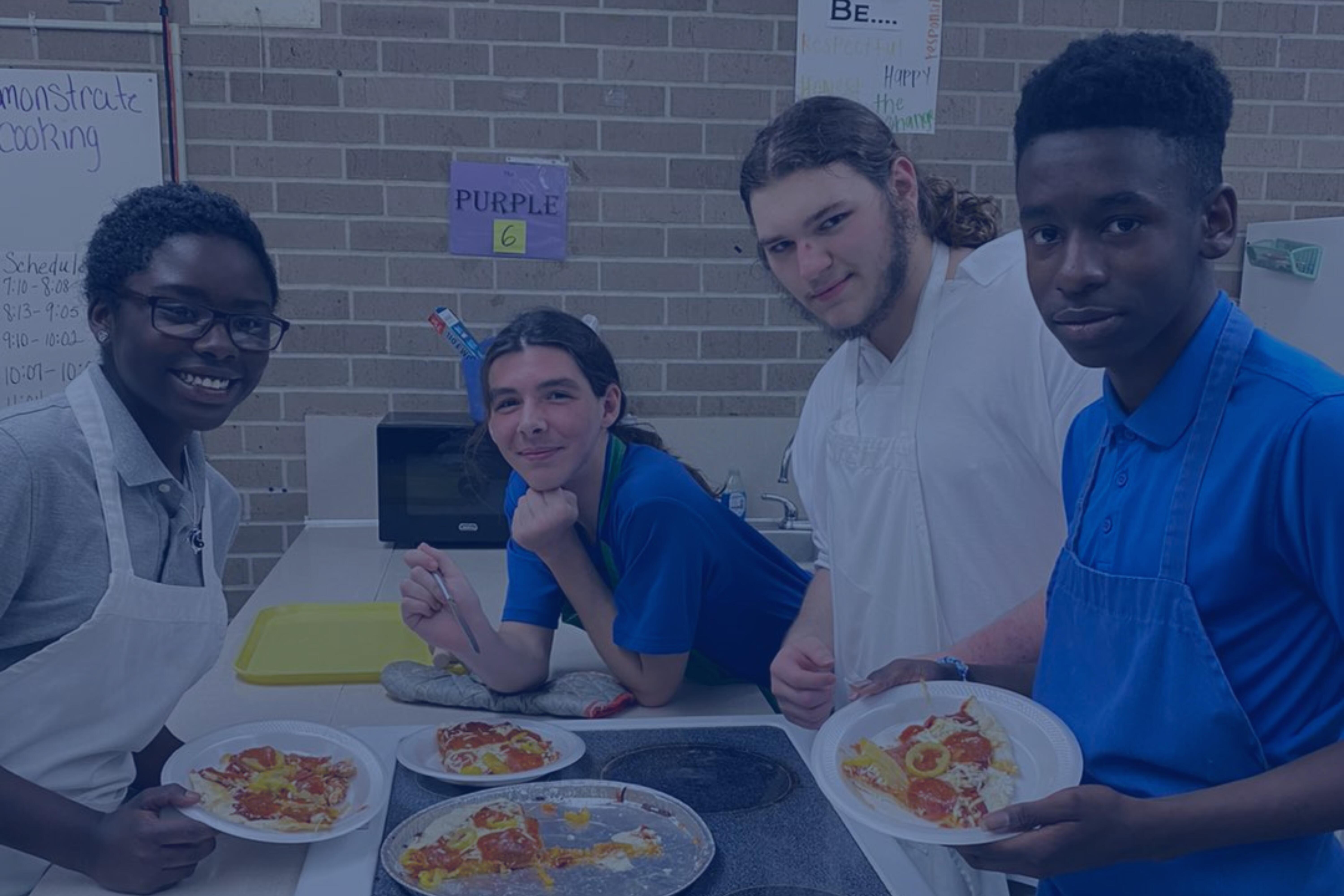 Students cooking pizza